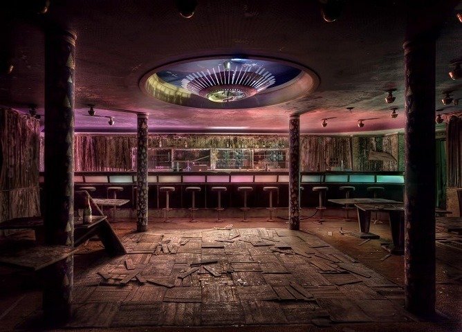An abandoned hotel and its bar deep inside a pine forest.