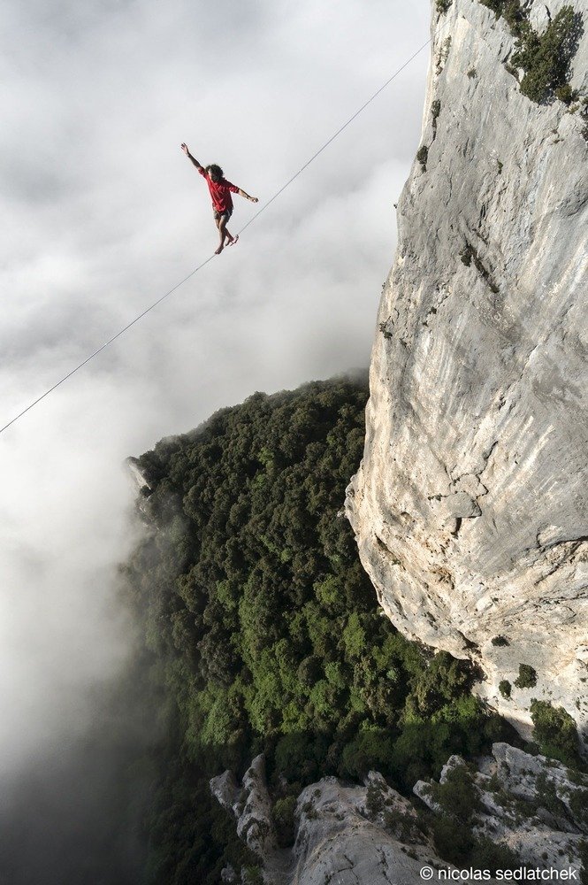 6. Theo Sanson balances himself on a 280 feet long highline at 980 feet of altitude with thick clouds in the back drop in Les Gorges Du Verdon in France.