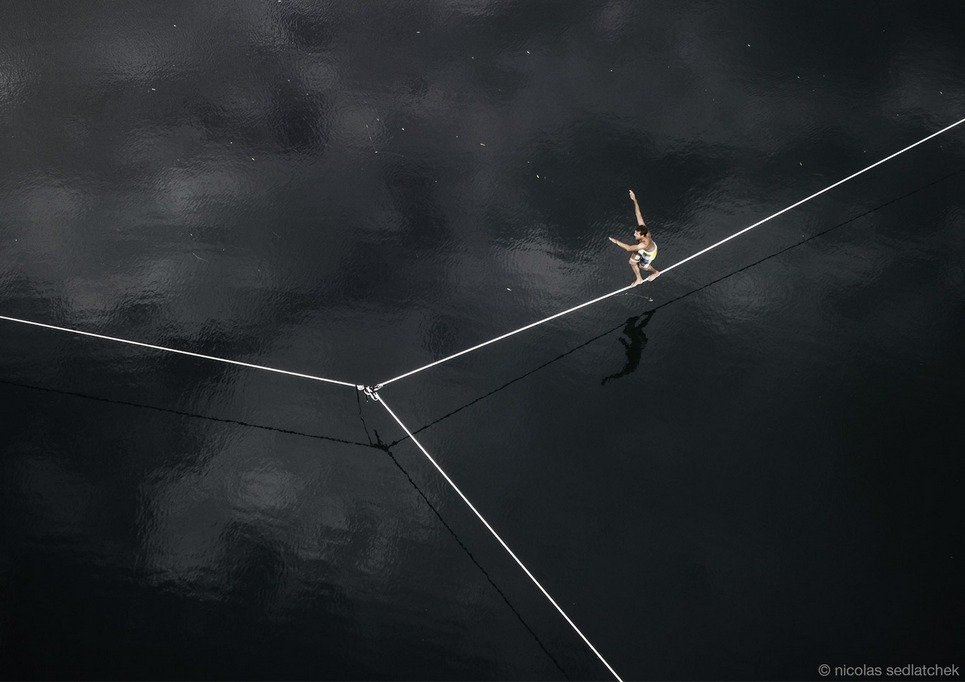 9. Jérémy Thétaz balancing himself on water while crossing a “space-waterline” on a small lake near Sion, Switzerland.