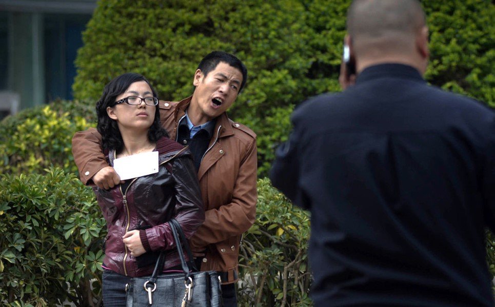 11. A man holding a woman hostage with a cleaver as a policeman negotiates - April 8, 2014.