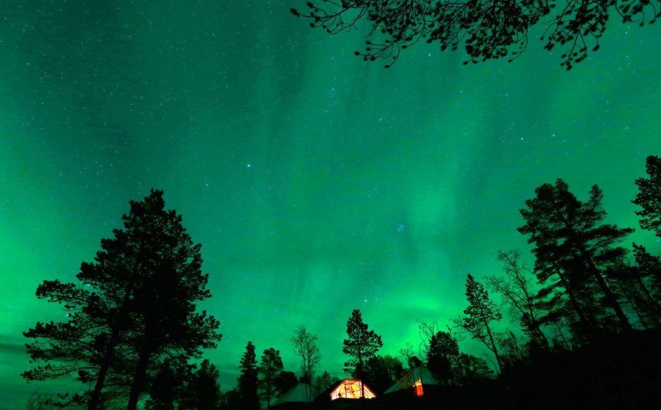 33. An Aurora Borealis (Northern Lights) is visible over a mountain camp north of the Arctic Circle, near the village of Mestervik - September 30, 2014.