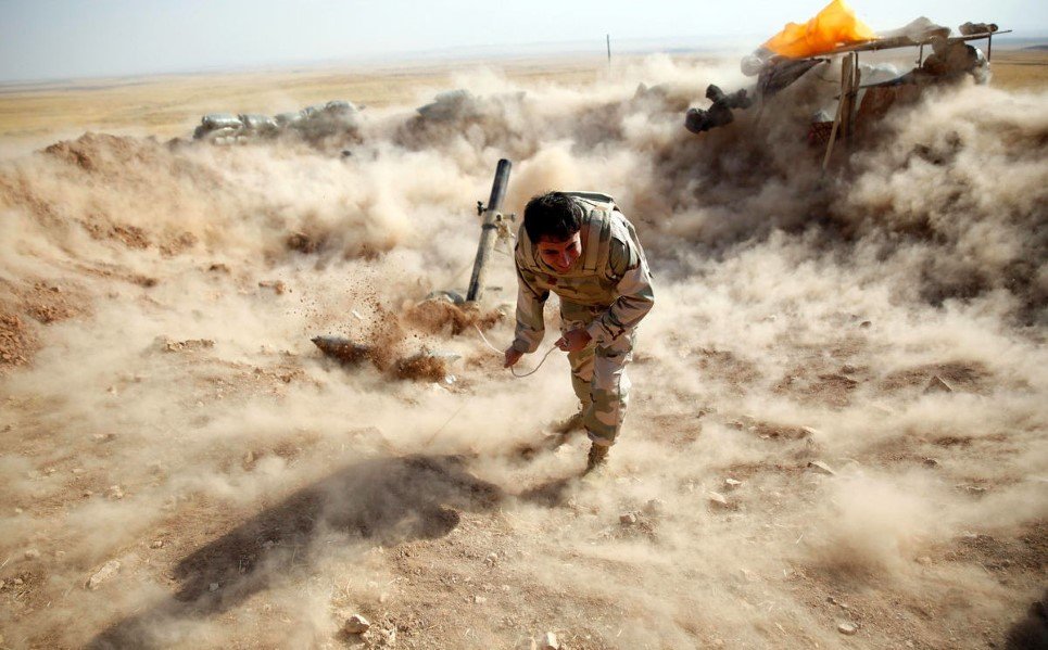 39. A Kurdish fighter launches mortar shells towards Islamic State (IS) controlled Zummar, near Mosul - September 15, 2014.