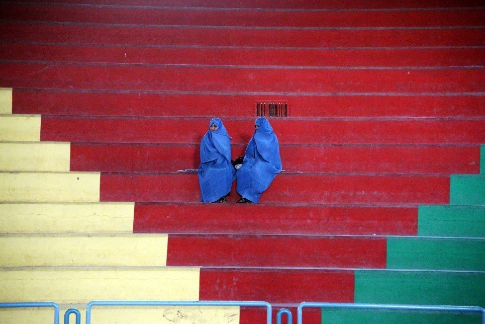 54. Afghan women sit in the rafters as they watch a women taekwondo match in Herat - November 13, 2014.