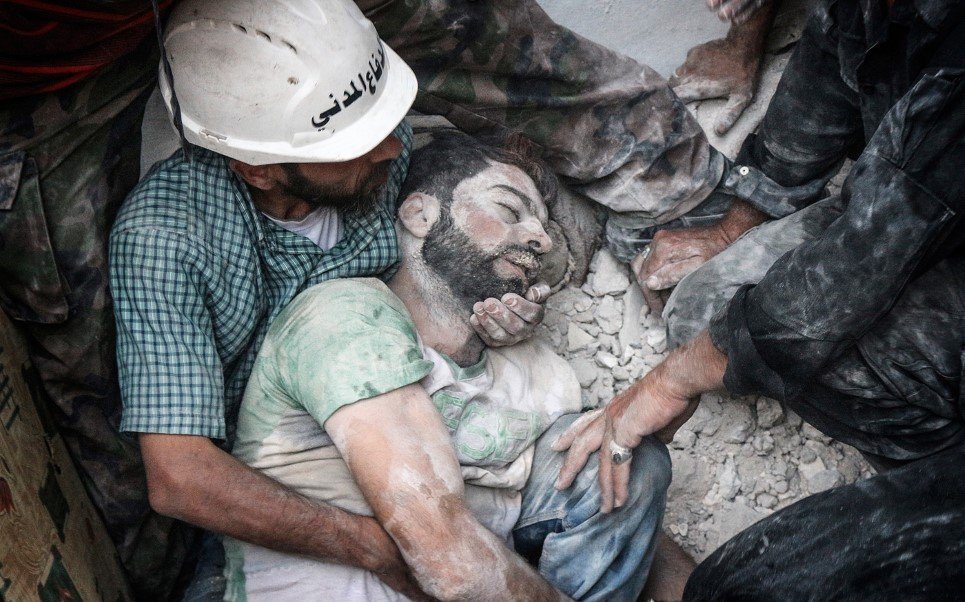 59. Search and rescue teams remove a body from the rubble after the Syrian regime shelled an opposition-controlled area of Aleppo - August 14, 2014.