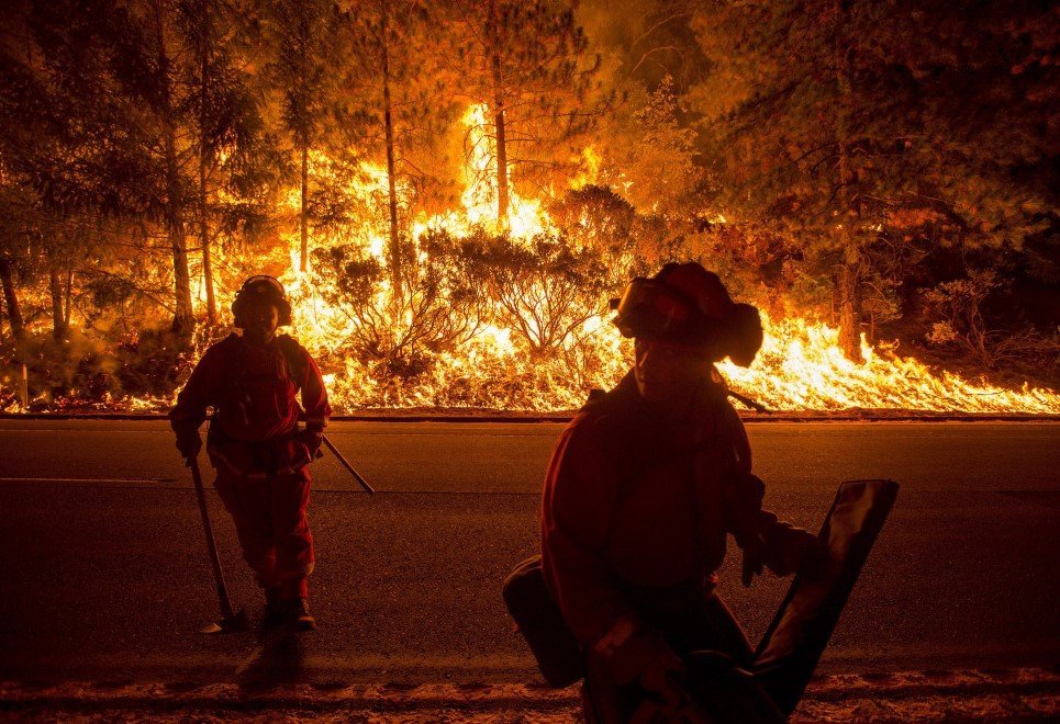 66. Firefighters battling the King Fire watch as a backfire burns along Highway 50 in Fresh Pond, California - September 16, 2014.