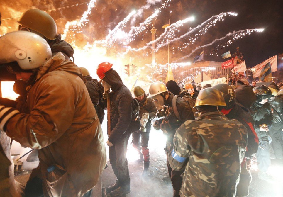 9. Fireworks explode near anti-government protesters during clashes with riot police at the Independence Square in Kiev - February 18, 2014.