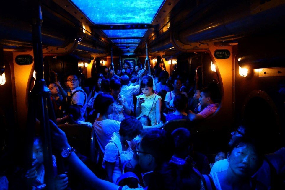 In the last ten years, mobile data, smartphones and social networks have forever changed our existence. Although this woman stood at the center of a jam-packed train, the warm glow from her phone told the strangers around her that she wasn't really there. She managed to slip away from "here" for a short moment; she's a node flickering on the social web, roaming the Earth, free as a butterfly. Our existence is no longer stuck to the physical here; we're free to run away, and run we will.