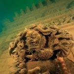 A Chinese city, forgotten after it was flooded when the government built a dam that turned the valley it was in into a lake, has resurfaced as an underwater adventure park for tourists. The ancient city of Shi Cheng was also known as the Lion City because it was located in the province of Zhejiang, where it was surrounded by the five Lion Mountains. Founded over 1,300 years ago, it vanished from view 53 years ago when the Chinese government decided they needed a new hydroelectric power station. A dam was built to create a man-made lake, and as the water rose, the city was left at the bottom of this new found body of water. Depending on where on the lake bottom it is, the city is between 85 and 131 feet underwater. And there it remained forgotten until Qiu Feng, a local official in charge of tourism, introduced the idea of using Shi Cheng as a destination for diving clubs. For the first try it was a voyage of discovery, and Qui said: "We were lucky. As soon as we dived into the lake, we found the outside wall of the town and even picked up a brick to prove it." It was later discovered that the entire town was intact, including wooden beams and stairs. Now the city had attracted interest from archaeologists and a film crew has been on site to record the preservation of the lost ruins.