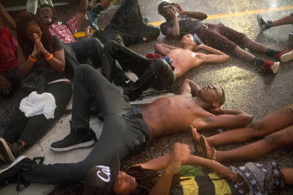 Demonstrators commemorate the one-year anniversary of the shooting of Michael Brown in Ferguson by staging a die-in – Aug. 9, 2015.