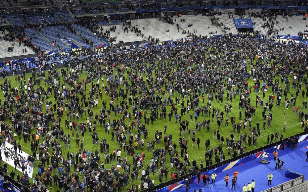 Football fans gather on the field of the Stade de France stadium following the friendly match between France and Germany, after a series of coordinated terrorist attacks across Paris in which 130 victims were killed – Nov. 13, 2015