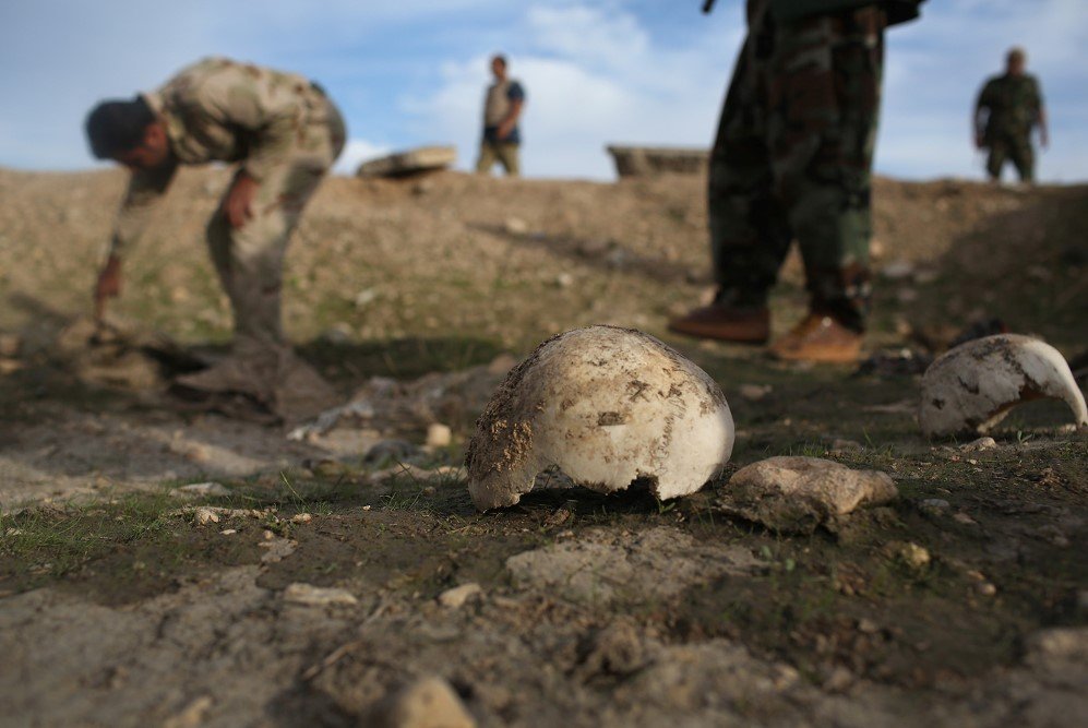 After emancipating the city from the Islamic State, Kurdish Peshmerga show what they say is a mass grave in Sinjar, Iraq of more than 50 Yazidis killed by ISIS – Nov. 15, 2015
