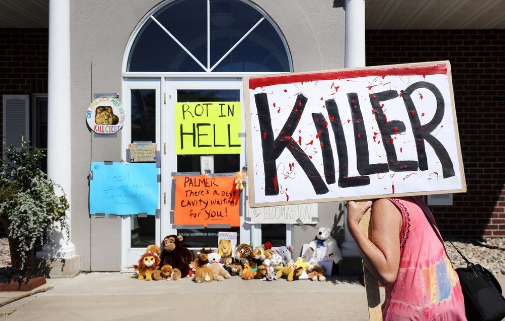 On July 29, protesters call attention to the poaching of Cecil the lion, in the parking lot of Dr. Walter Palmer’s River Bluff Dental Clinic in Bloomington, Minnesota. According to reports, the 13-year-old lion was lured out of a national park in Zimbabwe and killed by Palmer, who had paid at least $50,000 for the hunt.