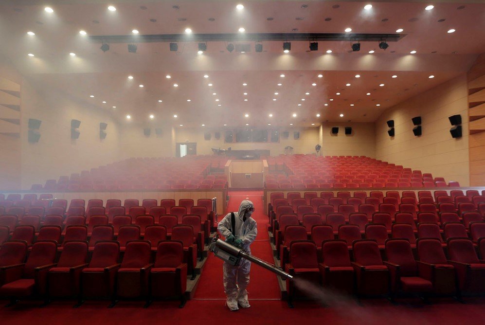 A worker sprays antiseptic solution as a precaution against the spread of MERS at an art hall in Seoul, South Korea – June 12, 2015.