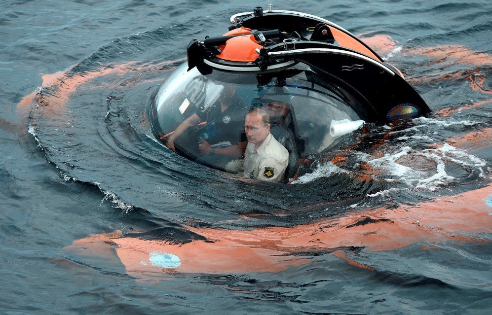 Russian President Vladimir Putin, sits on board a bathyscaphe as it dives into the Black sea along the coast of Sevastopol, Crimea – Aug. 18, 2015.