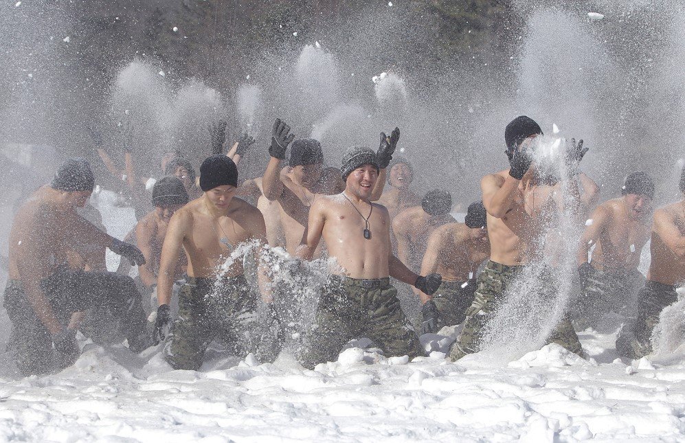 South Korean soldiers play in the snow during a winter military training exercise in Pyeongchang-gun, South Korea – Jan. 8, 2015