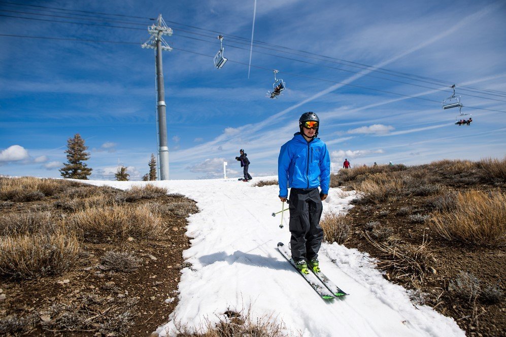 A skier threads his way through a patch of snow surrounded by dry ground at Squaw Valley Ski Resort which is a result of low snowfall caused by California’s historic drought – March. 21, 2015.