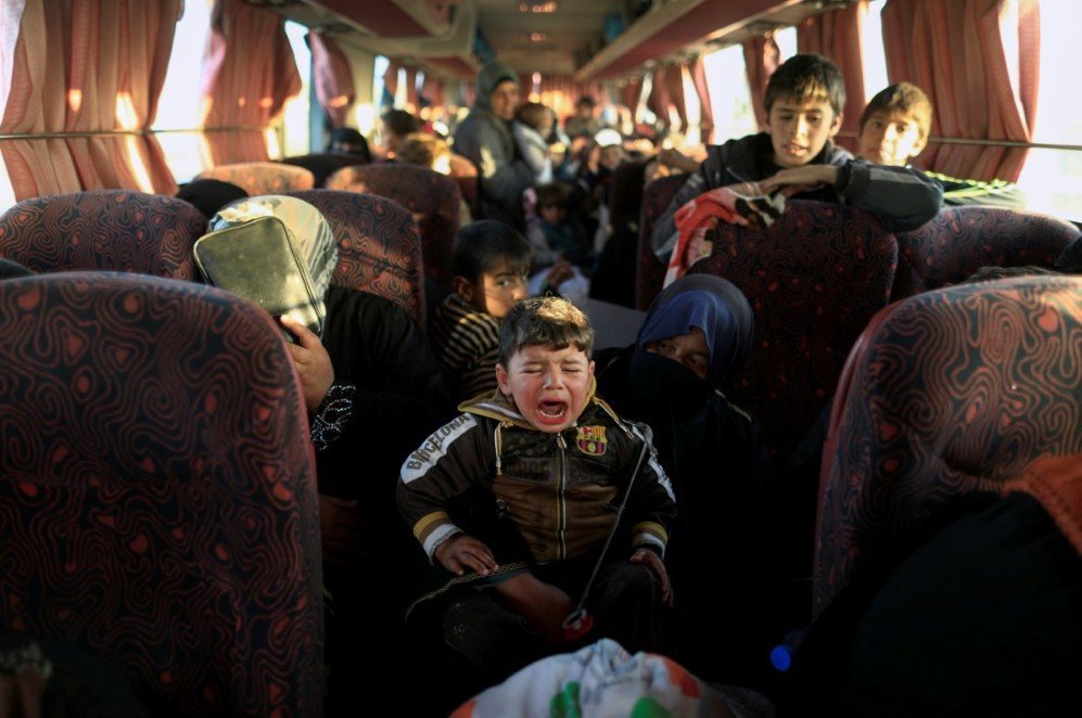 a boy who just fled a village controlled by islamic state fighters cries as he sits with his family inside a bus before heading to the camp at hammam ali south of mosul iraq on february 22 2017