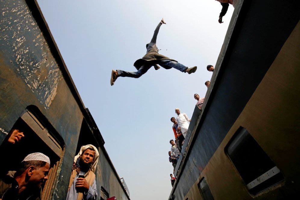 a commuter jumps between trains upon arrival at a station to attend akheri munajat the final supplication during biswa ijtema in tongi on the outskirts of dhaka on january 15 2017