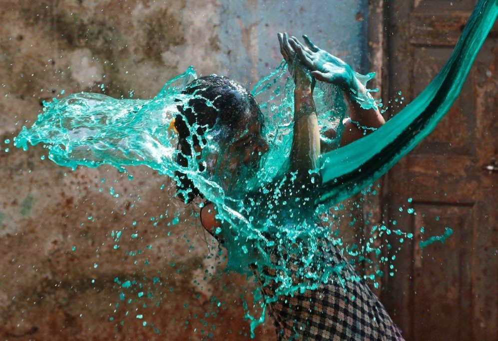 a girl reacts as colored water is thrown on her while celebrating holi the festival of colors in mumbai india on march 13 2017