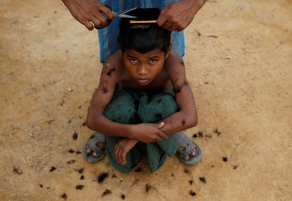 a rohingya refugee boy gets a haircut at kutupalong refugee camp near coxs bazar bangladesh on november 15 2017