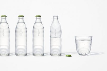 Nendo’s new glass bottle design captures the essence of rippling natural spring water