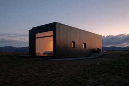 This minimalist vacation home features beautiful charred timber façade