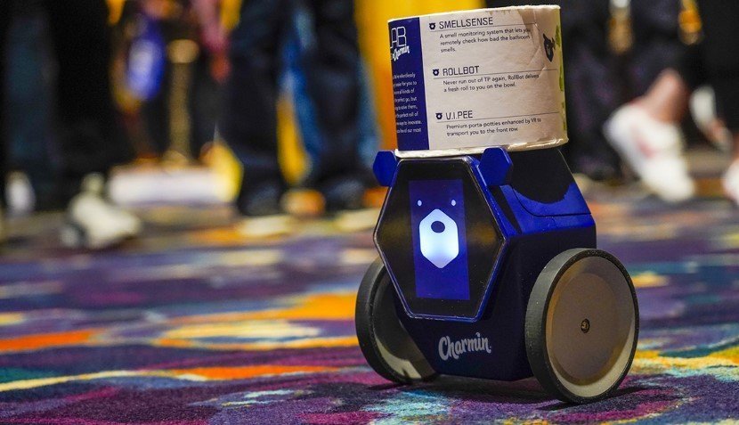 RollBot, a toilet paper-carrying droid developed by Charmin and Unit 9, carries a roll of toilet paper through a showroom, Monday, Jan. 6, 2020, in Las Vegas. (AP Photo/Jack Dempsey)