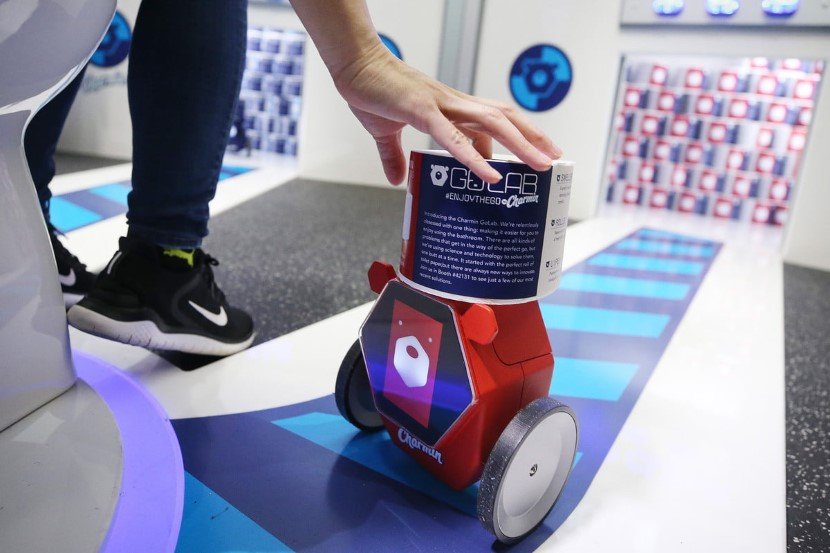 RollBot, a toilet paper-carrying droid developed by Charmin and Unit 9, carries a roll of toilet paper through a showroom, Monday, Jan. 6, 2020, in Las Vegas. (AP Photo/Jack Dempsey)