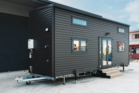 This tiny house has integrated storage under the stairs